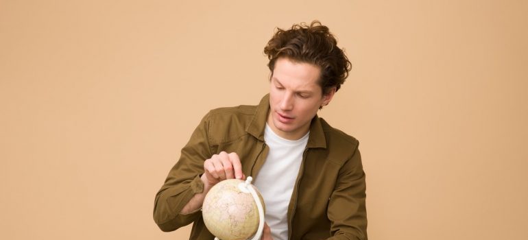 A man looking at the globe