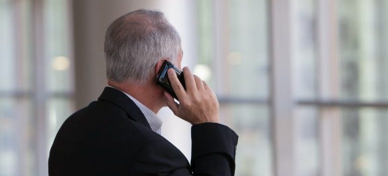 An elderly person talking on the phone